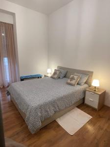 a bedroom with a bed with two pillows on it at Rivellino Guesthouse app 2 in Locarno