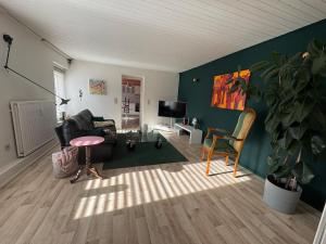 a living room with a couch and a chair at Appartement 2 chambres in Messancy