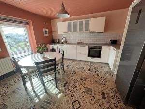 a kitchen with a table and a table and chairs at Appartement 2 chambres in Messancy