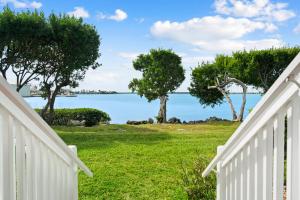 a view of the water from a house with a fence at 5035 "Villa del Sol"- Amazing Sunset Views! 2bed 3bath in Duck Key