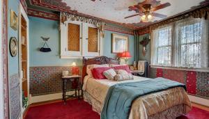 a bedroom with a bed and a ceiling fan at Schuster Mansion Bed & Breakfast in Milwaukee +14 photos