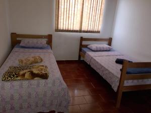 Giường trong phòng chung tại Real Hotel do Tatico