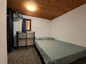 a bedroom with a large bed and a window at Бунгало Борче in Burgas