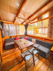 a living room with a table and a couch at Бунгало Борче in Burgas