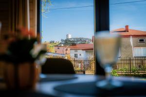 a glass of wine sitting on a table in front of a window at Polna 31 in Olsztyn