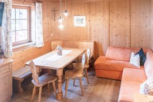 a dining room with a table and a couch at Gesenhof in Sesto +24 photos