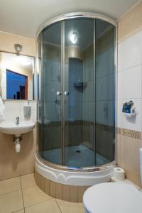 a bathroom with a shower and a toilet and a sink at Pensjonat Stańczyk in Krakow +20 photos