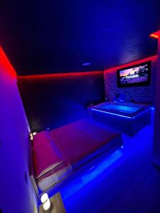 a room with a bed and a tub and a tv at Fifty shades in Bisaccia