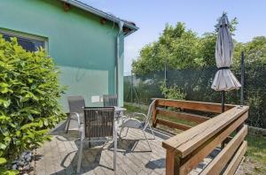 a patio with a table and an umbrella and a bench at Apartment MINT in Senec