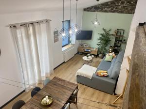a living room with a couch and a table at Ático en Jaca in Jaca