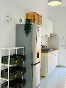 a kitchen with a refrigerator with baskets on it at Casa Capitan Coliving Coworking Digital Nomads in San Miguel de Abona
