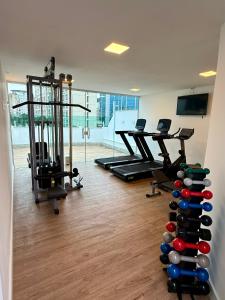 a gym with a bunch of exercise equipment in a room at Hotel Sheik Business in Rio de Janeiro