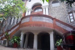 a building with a staircase on the side of it at Frenezia Hotel and Apartment Ikeja GRA in Ikeja