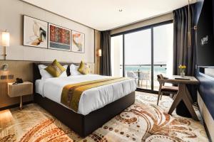 a hotel room with a bed and a large window at April Hotel in Aqaba