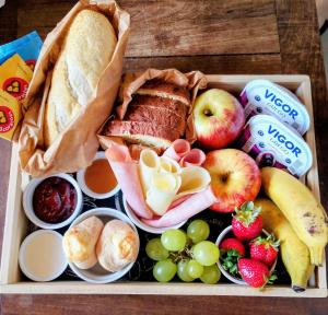a tray of food with bread fruit and other foods at Morada da Mata in Candelária