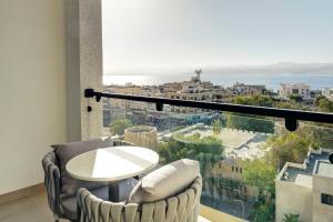a room with a table and chairs and a large window at April Hotel in Aqaba