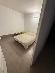 a bedroom with a bed and a tiled floor at u limone in Porticcio