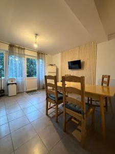 a dining room with a wooden table and chairs at u limone in Porticcio