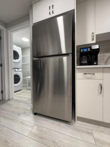 a large stainless steel refrigerator in a kitchen at Slice Of Paradise in Calgary