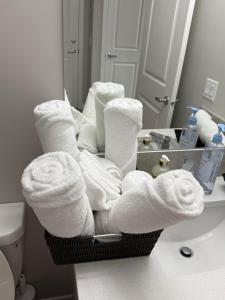 a basket of towels in front of a bathroom mirror at Slice Of Paradise in Calgary +19 photos