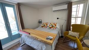 a small bedroom with a bed and a chair at Propre Confortable Près des services in Saint-Joseph-de-Beauce +21 photos