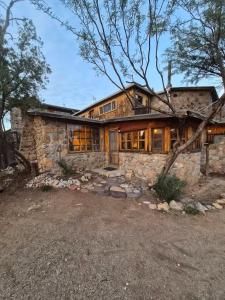 a large stone house with a large window at Tucson Mountain Guest Ranch in Tucson