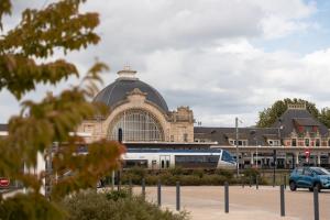 a train is parked in front of a building at Yassam -Le Studio 301 in Saint-Brieuc