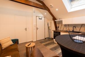 a kitchen and a living room with a table at Yassam -Le Studio 301 in Saint-Brieuc
