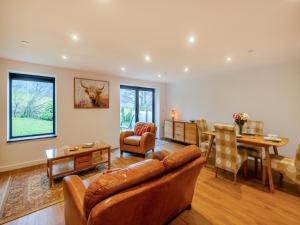 a living room with a couch and a table at The Aran - Uk51067 in Frongoch