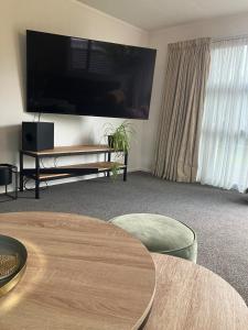 a living room with a large flat screen tv at Cozy, Modern, Quiet House in Westport