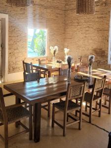 a dining room with a wooden table and chairs at La estancia Yapeyú in Yapeyú +58 photos