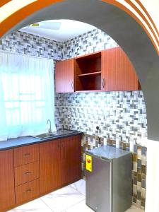a kitchen with a sink and a counter top at Happy Home in Weija