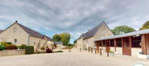a building with two large stone buildings and a street at Les Pérelles in Saint-Vigor-le-Grand +28 photos