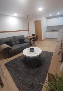 a living room with a couch and a table at Casa MENDEZ - ALLARIZ in Ourense