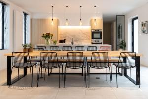 a kitchen and dining room with a wooden table and chairs at DOS22 Vakantiewoning I De Haan Wenduine in Zuienkerke