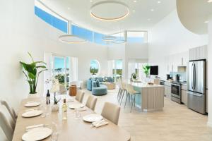 a kitchen and living room with a table and chairs at Ellipse Resort, Grace Bay in Providenciales