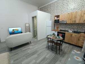 a kitchen with a table and a stove top oven at Seaside House in Ponta Delgada