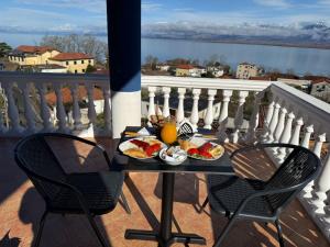 a tray of food on a table on a balcony at The Blue House in Shkodër
