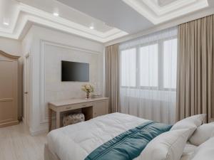 a bedroom with a bed and a desk with a television at Old Town Boutique Hotel in Bucharest