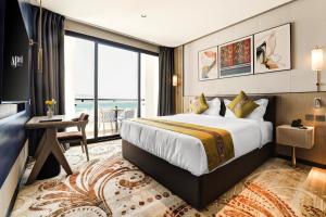 a hotel room with a bed and a large window at April Hotel in Aqaba