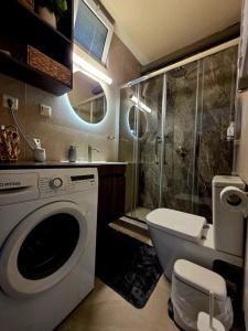 a bathroom with a washing machine and a shower at Hermes Modern Apartment in Alexandroupoli +88 photos