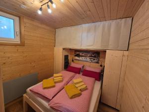 a room with a bed in a wooden cabin at Chaletwohnung Innerkrems in Innerkrems