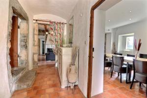 a living room with a kitchen and a dining room at La Rochere in Sampzon