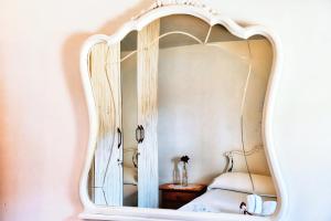 a bedroom with a mirror on the wall at Masia Campos Culla in Culla +31 photos