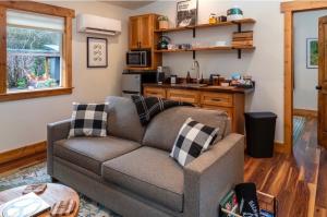 a living room with a couch and a kitchen at Backwoods Cabins in Carson +7 photos
