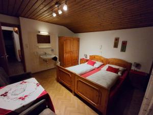 a bedroom with two beds and a sink at Gästehaus Gapp in Wildermieming