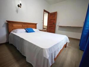 a bedroom with a large white bed with a blue pillow at Label résidence 2 in Grand-Baie +20 photos