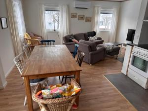 a living room with a table and a couch at Ellös Holiday apartment in Ellös