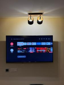 a flat screen tv hanging on a wall at Apartmán Mia 1 in Liptovský Mikuláš