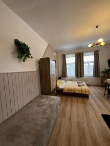 a bedroom with two beds in a room with wooden floors at Ubytování Na Kovárně in Smržovka +39 photos